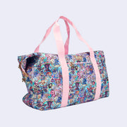 Boxy duffel bag with pastel pink colored fabric detailing, around the zipper and as the handles/straps. Bag has a small "tokidoki" nameplate on the upper center and is covered completely in a busy colorful pattern featuring tokidoki characters with with galactic and sci fi imagery.