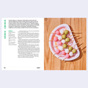 Dango on sticks with a recipe card on a wooden surface
