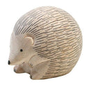 White wooden hedgehog figurine on a white background