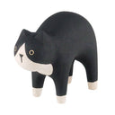 Wooden figurine of a black and natural wood color cat with an arched back.