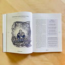 Open magazine spread featuring a blue and black illustration of a man sitting in a freezer aisle with frozen pizzas around him, accompanied by an article on the topic.