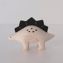 Wooden figure of a dinosaur with a black spiked back on a white background