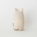 Small white wooden figurine of a mouse with a painted on curling tail and small whiskers.