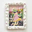 Painting of a green haired cartoon character wearing a pink dress and walking down a street while holding 2 sticks of dango, with tiny bunnies dancing on them. Piece is framed in a deco-den frosting themed frame.