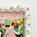 Painting of a green haired cartoon character wearing a pink dress and walking down a street while holding 2 sticks of dango, with tiny bunnies dancing on them. Piece is framed in a deco-den frosting themed frame.