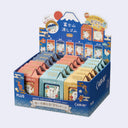 Display box of colorful erasers with Mount Fuji design on a light blue background
