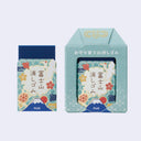 Two erasers with decorative boxes and packaging with Japanese text and graphics on a light blue background