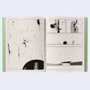 Open book with black and white illustrations on a light background