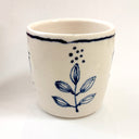 White mug with blue floral design on a white background