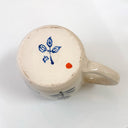 Ceramic mug with blue and red design on a white background