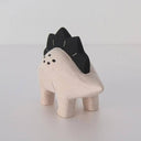 Wooden figure of a dinosaur with a black spiked back on a white background