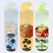 3 skateboard decks with floral themed illustrations.