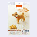 Packaging for a felting kit for a Shiba Inu dog, standing and smiling with text in Japanese detailing the contents of the kit.