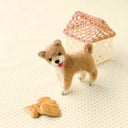 Wool felted dog sculpture, a shiba inu with a cute tongue-out expression.