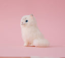 Needle felting of a Persian cat, white a fluffy sitting with a happy, curious expression.