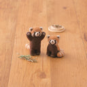 2 needle felted red panda (lesser panda) sculptures. One stands with its arms raised, the other sits.