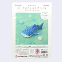 Packaging for a needle felting kit of a whale shark, a flat, blue shark with a white underbelly and white spots.