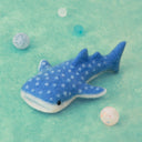A needle felting kit of a whale shark, a flat, blue shark with a white underbelly and white spots.