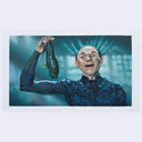 Person in a dark costume holding a fish against a blue background