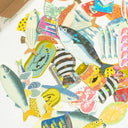 Scattered array of fish themed flake stickers, all with a slight holographic shine.
