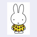 White postcard of Miffy standing and wearing a floral yellow dress with red flower and green leaves.