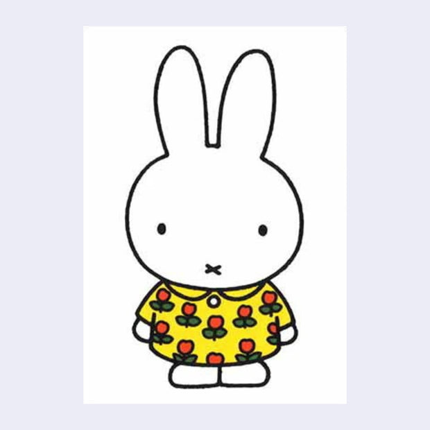 White postcard of Miffy standing and wearing a floral yellow dress with red flower and green leaves.