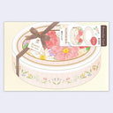 Decorative card with floral design and ribbon on a light yellow background