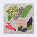 Light gray square hand towel with an illustration of stylized green and purple trees, with a fluffy pink fox standing under them.