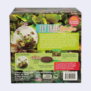 Product packaging for a Fly Trap Garden - glass terrarium kit where a Venus Fly Trap can be grown. Backside so contents and a brief description.