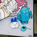 Painting of an anime style girl wearing a pink maid's outfit and white stockings and sitting on the ground with one leg extended out. She has a handheld gaming console and is surrounded by lots of plush dolls.