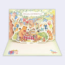 Greeting card with Japanese text and an illustration of a group of forest animals having a birthday party. Card pops out with illustration becoming 3D