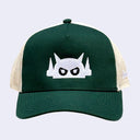 Forest green cap with a white embroidered design of a robot head with an angry stare. Back of the hat is a cream colored mesh.