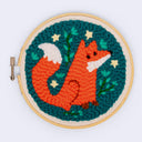Embroidery hoop with a fox design on a teal background