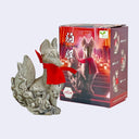 Decorative fox figurine made to look like it's carved from stone, with red ribbon next to its packaging box on a white background