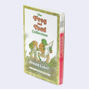 The Frog and Toad Collection book set by Arnold Lobel, showing the front cover of the first book and the red spines of the remaining books in the set, photographed on a light gray background.