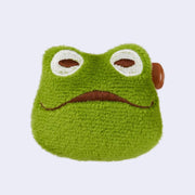 Green frog-shaped plush toy with a sad expression on a white background