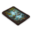 A semi-3D clay artwork, shaped like a card depicting a whimsical forest stream scene with a green frog resting on a rock, surrounded by brown branches, green leaves, and blue-green water, set against a plain white background. Scene is kept within a clay frame made to look like wood.