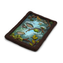 A semi-3D clay artwork, shaped like a card depicting a whimsical forest stream scene with a green frog resting on a rock, surrounded by brown branches, green leaves, and blue-green water, set against a plain white background. Scene is kept within a clay frame made to look like wood.