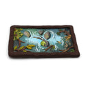 A semi-3D clay artwork, shaped like a card depicting a whimsical forest stream scene with a green frog resting on a rock, surrounded by brown branches, green leaves, and blue-green water, set against a plain white background. Scene is kept within a clay frame made to look like wood.