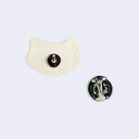 3D ceramic brooch/pin of a frog's head - green in coloring with 2 large eyes and a closed mouth. Back view to show the pin back and metal clasp.