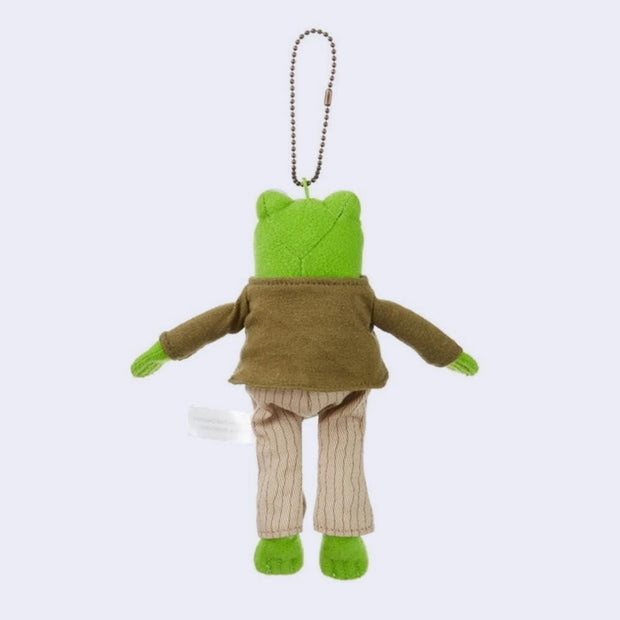 Plush toy frog character with a green jacket and brown outfit on a white background