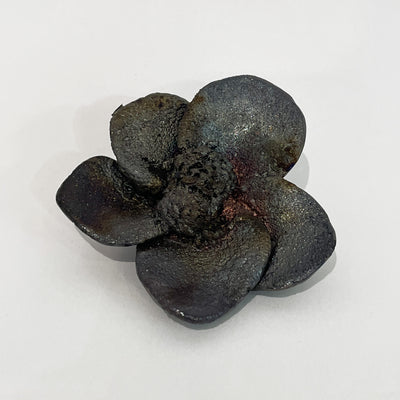 Black ceramic flower that looks charred.