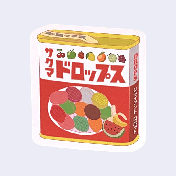 Die cut sticker of a tin can of fruit flavored candy drops, featuring packaging similar to Sakuma Drops in an illustrative style.