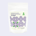 Matcha tea package with floral design on a light purple background