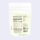 Nutrition facts label on a package of green tea powder with a light purple background