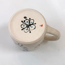 Ceramic mug with a floral design on a white background