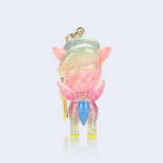 Semi transparent vinyl figure of a unicorn with glitter injection, primarily pink with blue and pink accents. Stars and moons decorate the figure, which is attached to a gold keychain. Back view.