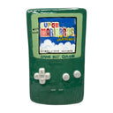 Ceramic sculpture of a green Gameboy Color, with the load screen of Super Mario Bros. Deluxe on it.