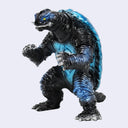 A monster action figure resembling a giant turtle-like creature with a black body, blue shell, and small yellow eye, posed against a plain light gray background.