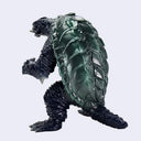 A monster turtle figurine with a dark green scaly shell and a black textured body, shown from a three-quarters angle against a light gray background.